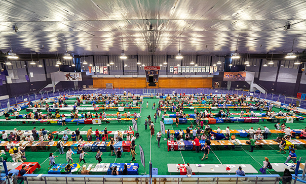 Banquet-style tables with booths set up in Thompson Arena